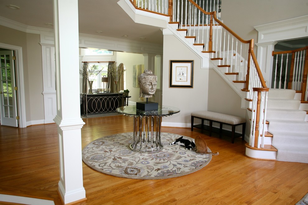Mid-sized transitional medium tone wood floor and brown floor foyer photo in Baltimore with gray walls