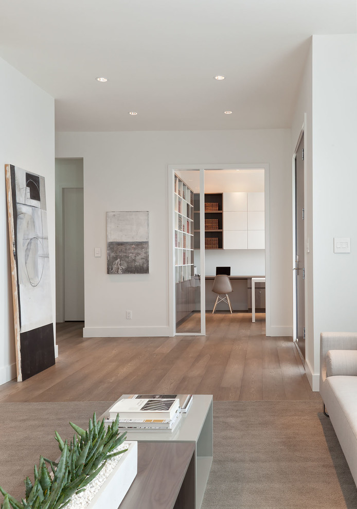 Expansive modern foyer in Vancouver with white walls, medium hardwood flooring, a single front door and a dark wood front door.