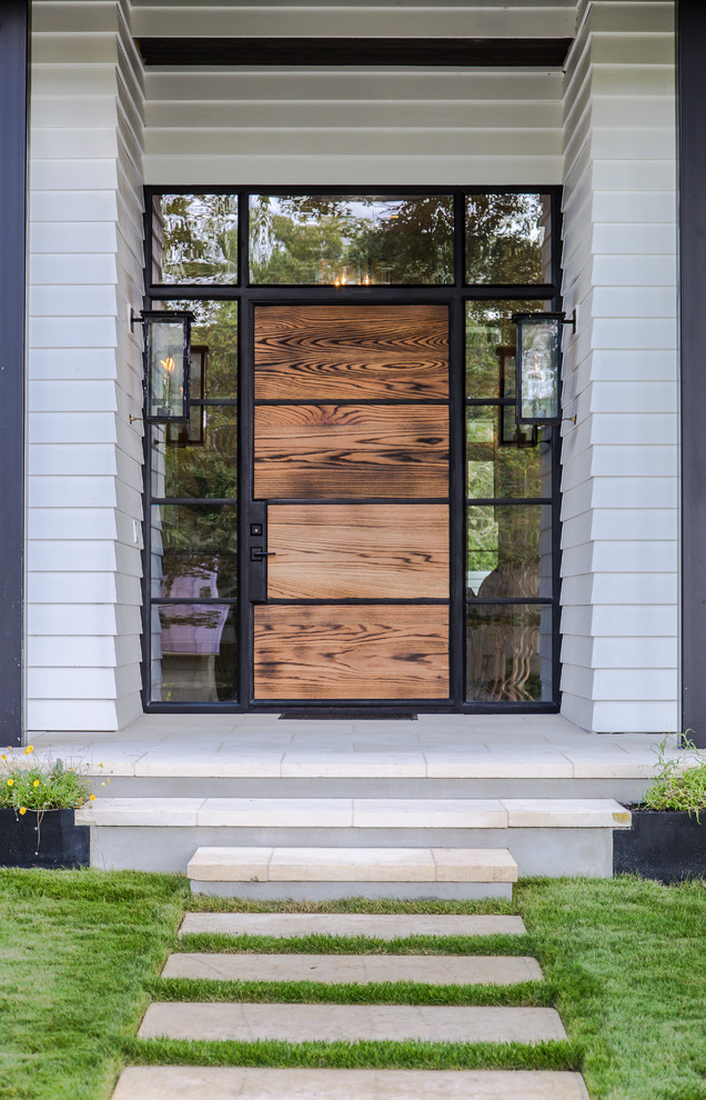 Elegant entryway photo in Austin with a medium wood front door