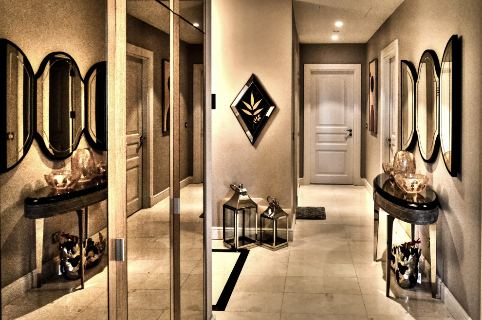 This is an example of a medium sized modern foyer in Other with beige walls, travertine flooring and beige floors.