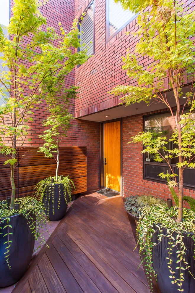 Contemporary entrance in San Francisco with a single front door and a light wood front door.