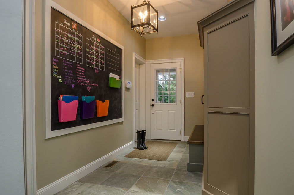 Entryway - mid-sized traditional slate floor entryway idea in New York with beige walls and a white front door