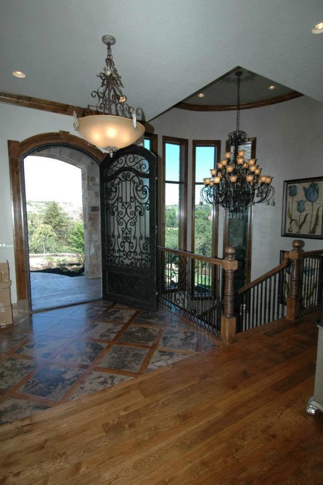 Inspiration for a large timeless medium tone wood floor entryway remodel in Salt Lake City with beige walls and a metal front door