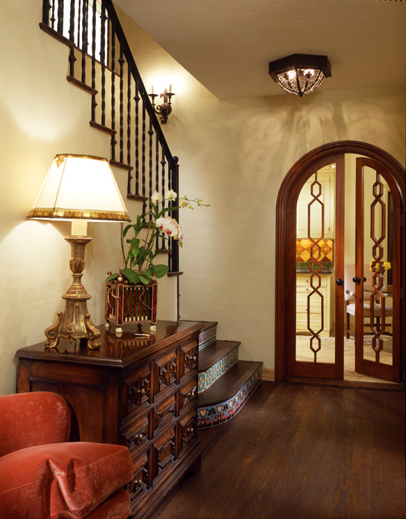 Foyer - mid-sized mediterranean dark wood floor foyer idea in Miami with beige walls and a dark wood front door