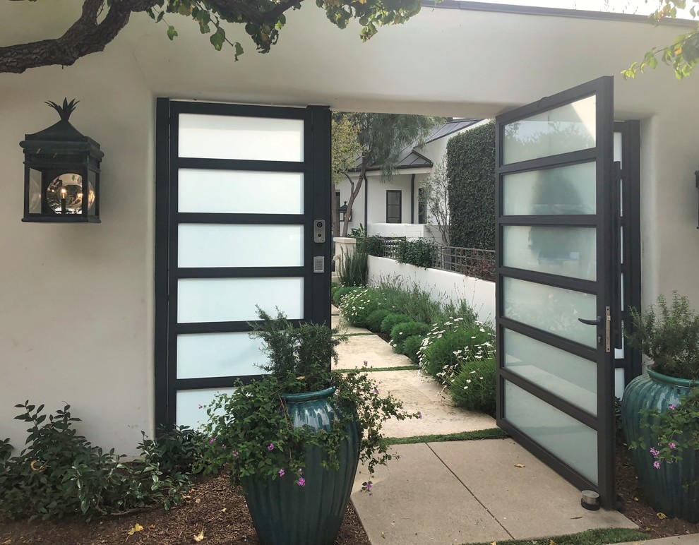 Design ideas for an expansive modern front door in Los Angeles with white walls, concrete flooring, a double front door, a grey front door and grey floors.