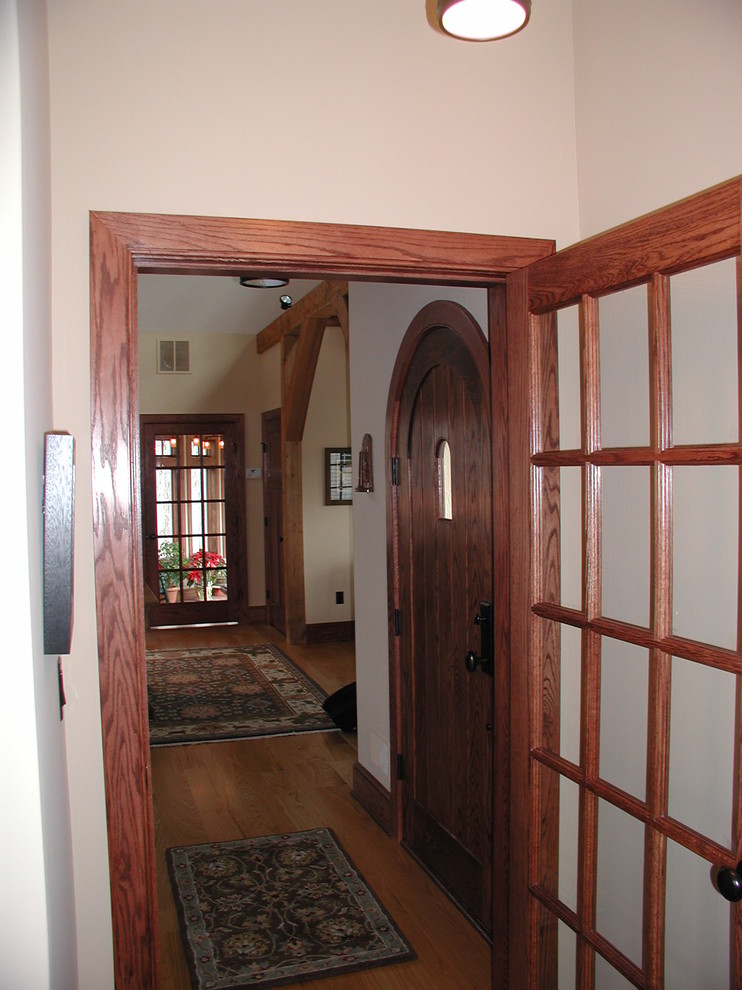 Photo of a traditional foyer in New York with medium hardwood flooring and a dark wood front door.