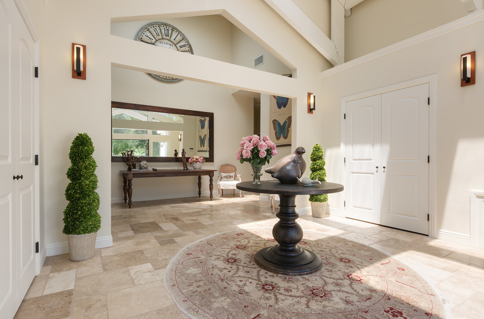 Large rural foyer in Other with white walls, travertine flooring, a double front door, a black front door and beige floors.