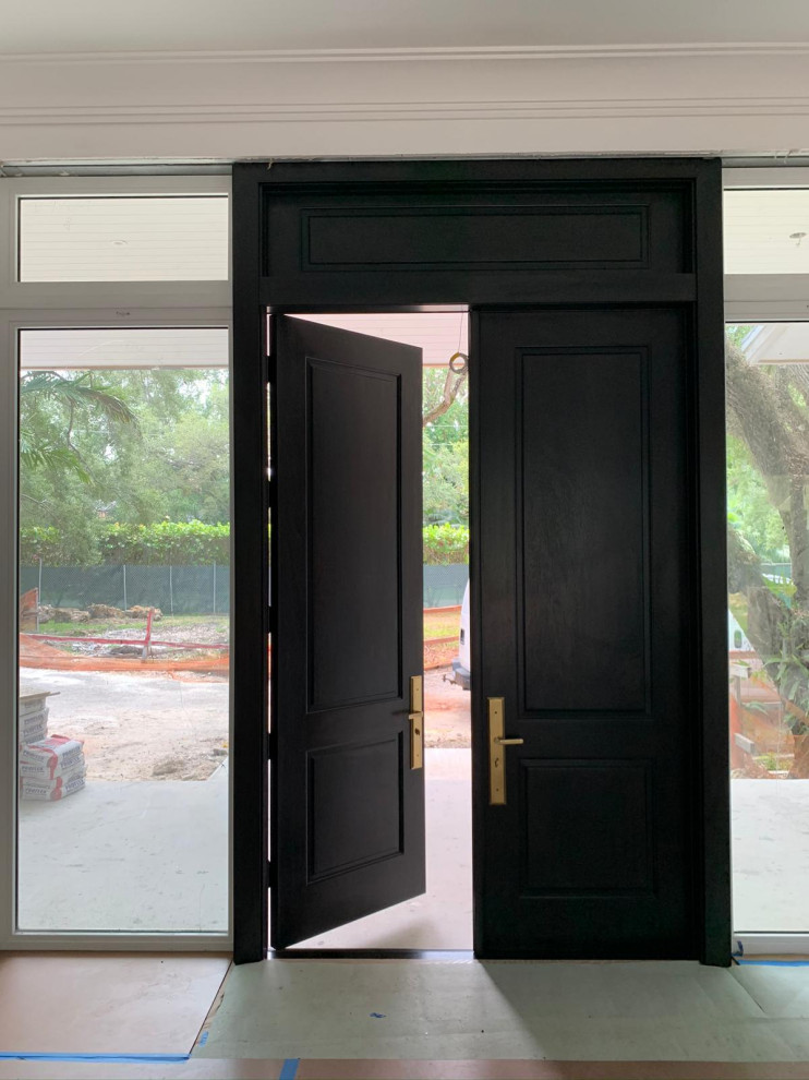На фото: входная дверь в стиле модернизм с бежевыми стенами, полом из керамогранита, двустворчатой входной дверью, входной дверью из дерева среднего тона, белым полом и деревянным потолком