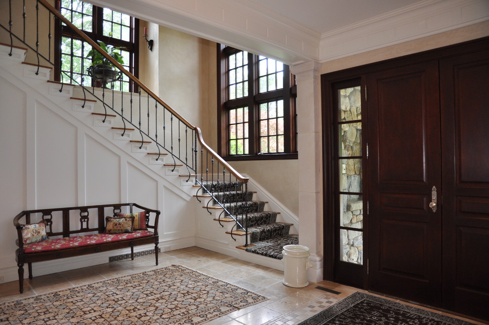 This is an example of a medium sized classic foyer in New York with beige walls, a double front door, a dark wood front door and ceramic flooring.