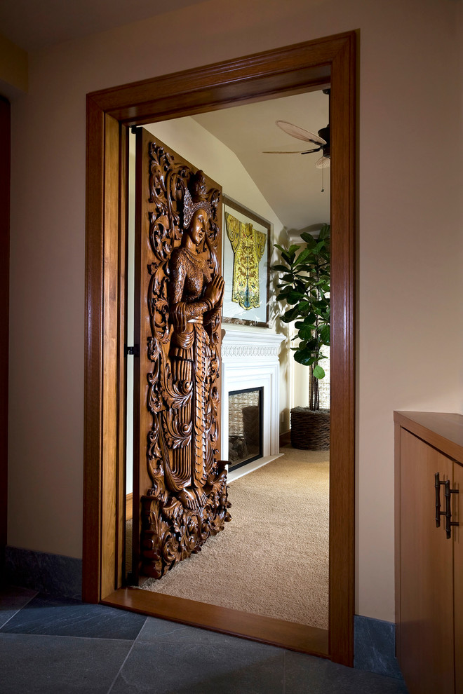 Inspiration for a mid-sized eclectic gray floor entryway remodel in Orange County with beige walls and a brown front door