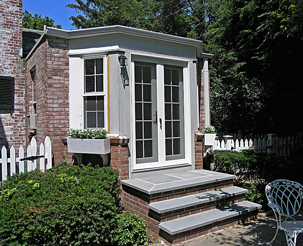 Example of a mid-sized arts and crafts entryway design in Bridgeport with a white front door