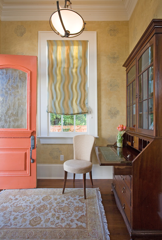 Inspiration for a timeless dark wood floor single front door remodel in New Orleans with yellow walls and an orange front door