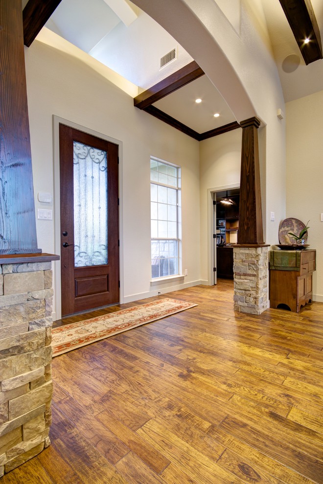 Photo of a large classic foyer in Austin with beige walls, medium hardwood flooring, a single front door and a medium wood front door.
