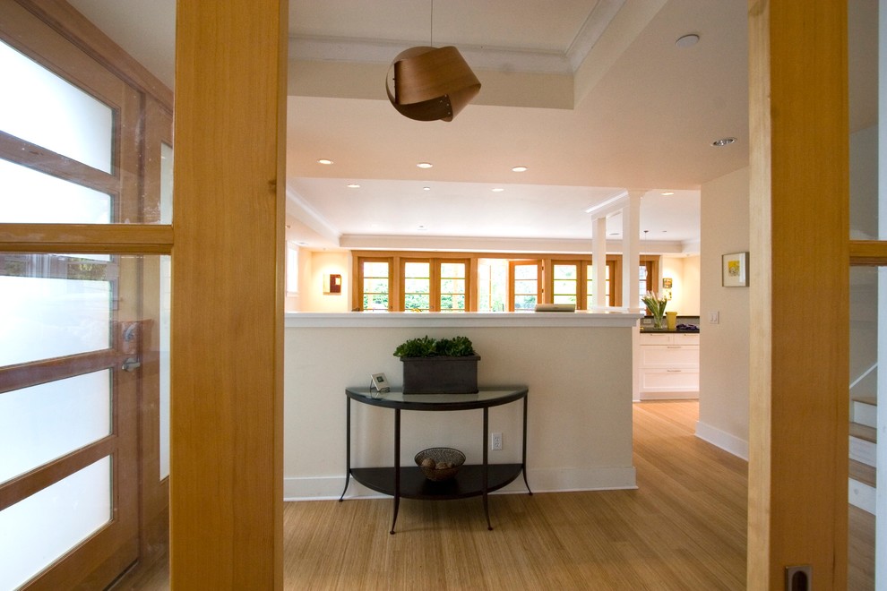 Mid-sized trendy bamboo floor and beige floor entryway photo in Seattle with beige walls and a light wood front door