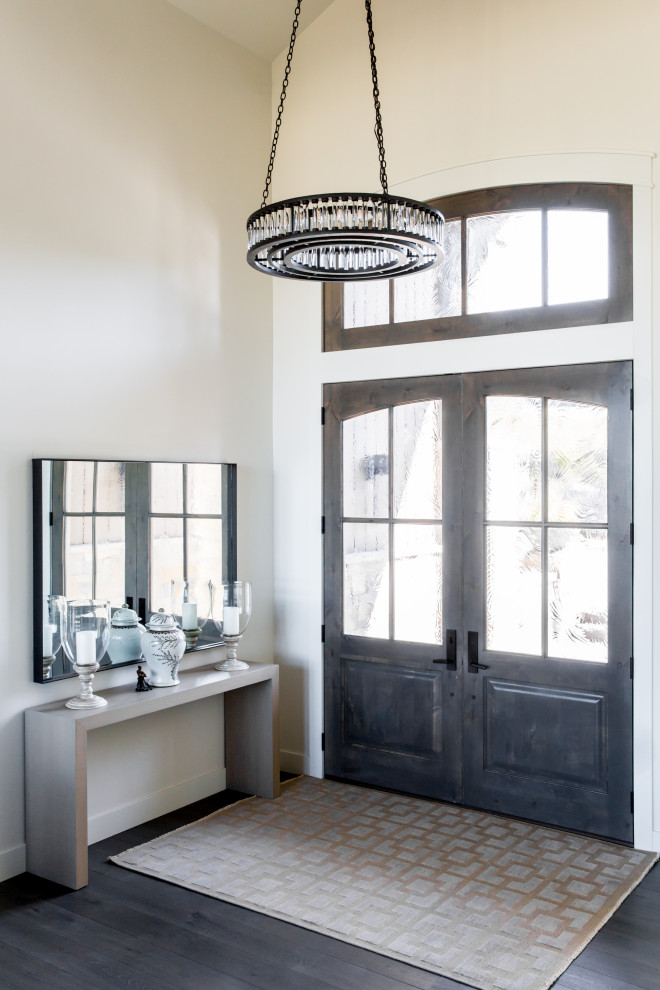 This is an example of a medium sized rustic foyer in Salt Lake City with white walls, dark hardwood flooring, a double front door, a dark wood front door and brown floors.