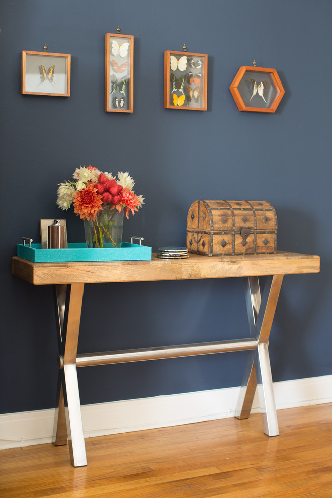 Inspiration for a small eclectic light wood floor entryway remodel in Los Angeles with blue walls