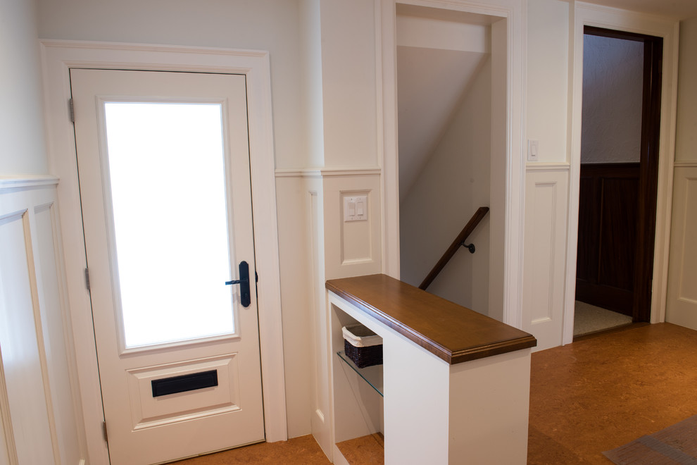 Стильный дизайн: входная дверь среднего размера в классическом стиле с белыми стенами, одностворчатой входной дверью, белой входной дверью и пробковым полом - последний тренд