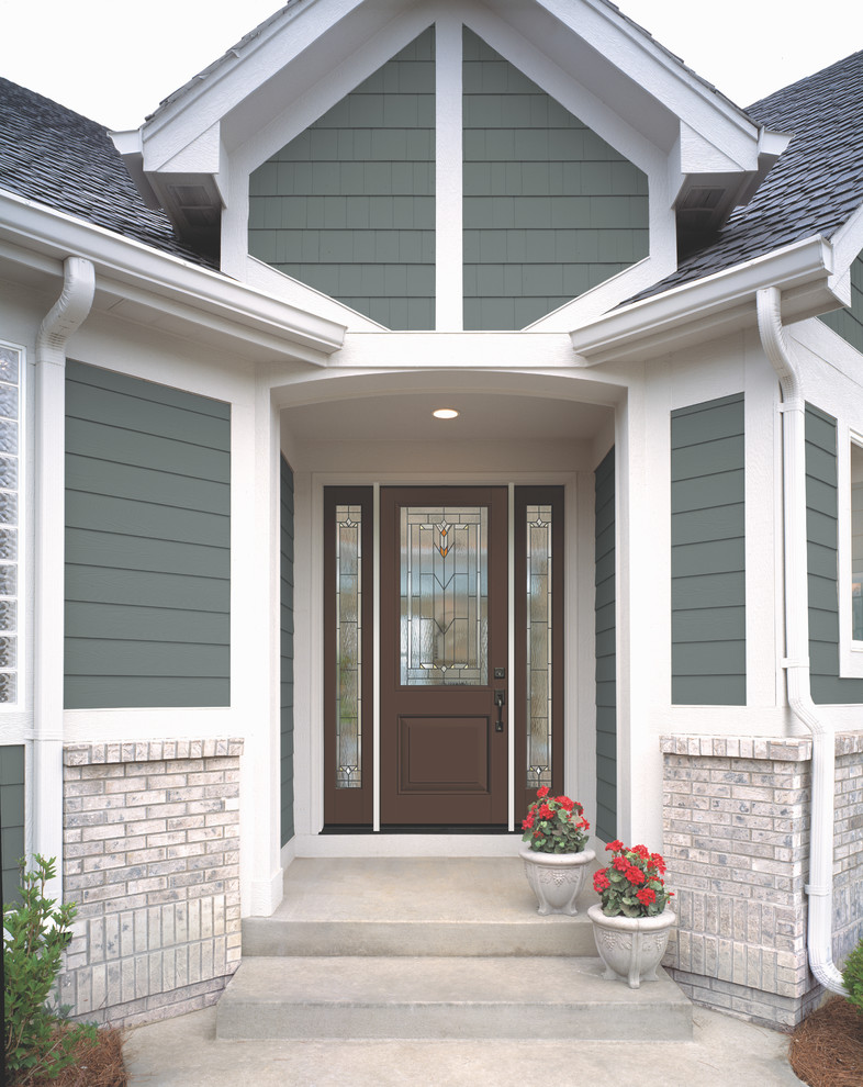 This is an example of a medium sized traditional front door in Boston with a single front door and a dark wood front door.