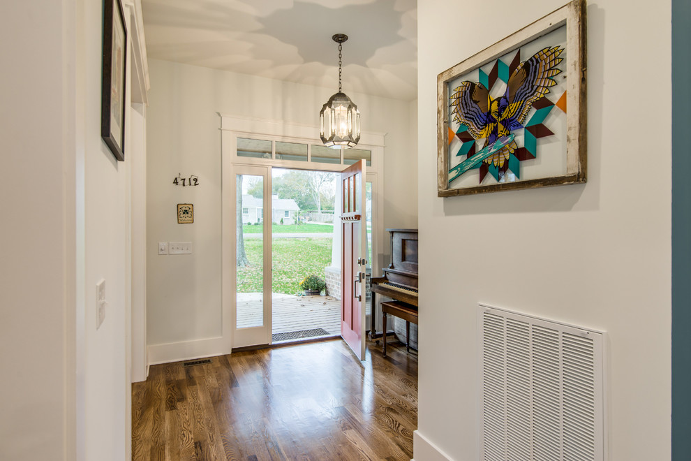Medium sized traditional foyer in Nashville with white walls, medium hardwood flooring, a single front door and a red front door.