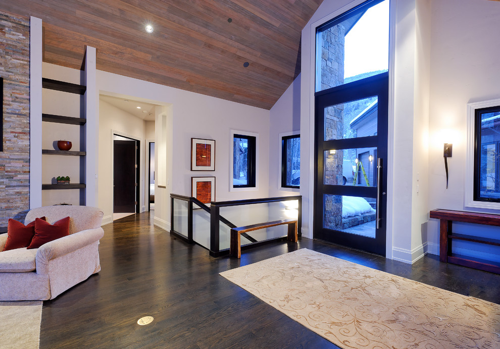 This is an example of a rustic foyer in Denver with white walls.