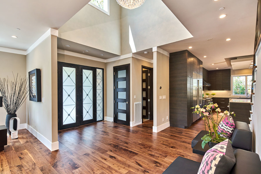 Example of a huge trendy dark wood floor entryway design in San Francisco with beige walls and a brown front door