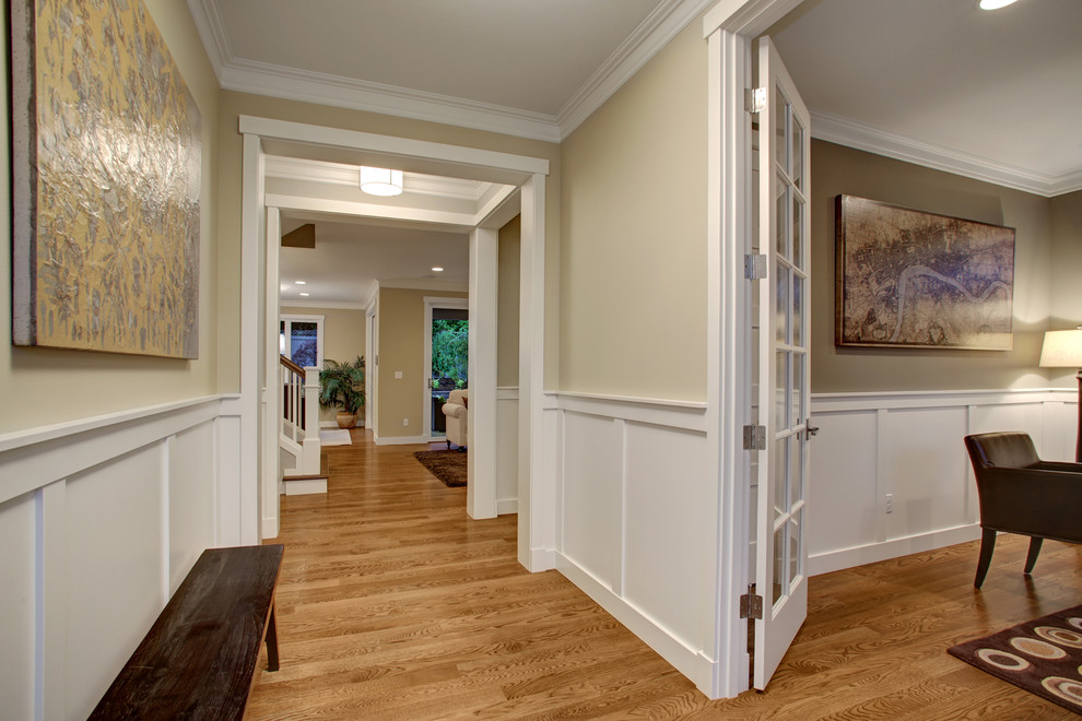 Example of an arts and crafts medium tone wood floor entryway design in Seattle with beige walls and a gray front door