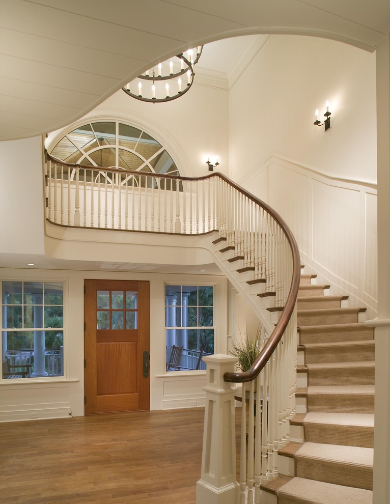 Inspiration for a timeless entryway remodel in Charleston with white walls and a medium wood front door