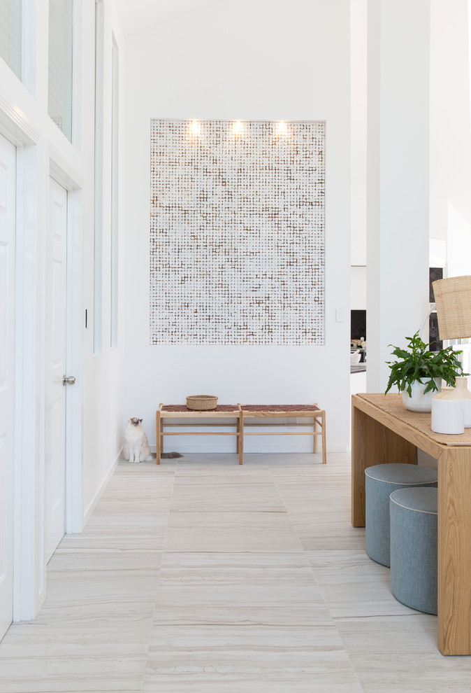 Example of a large trendy porcelain tile and gray floor entryway design in Gold Coast - Tweed with white walls and a white front door