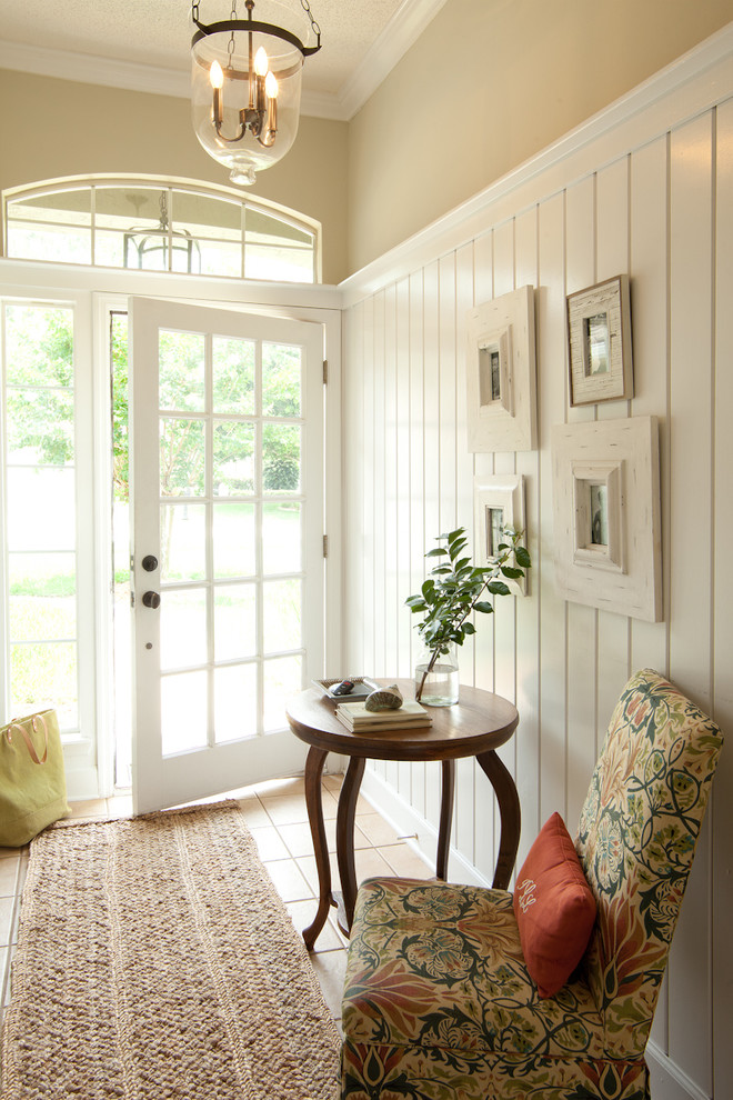 Inspiration for a mid-sized coastal ceramic tile and beige floor entryway remodel in Jacksonville with a glass front door and beige walls