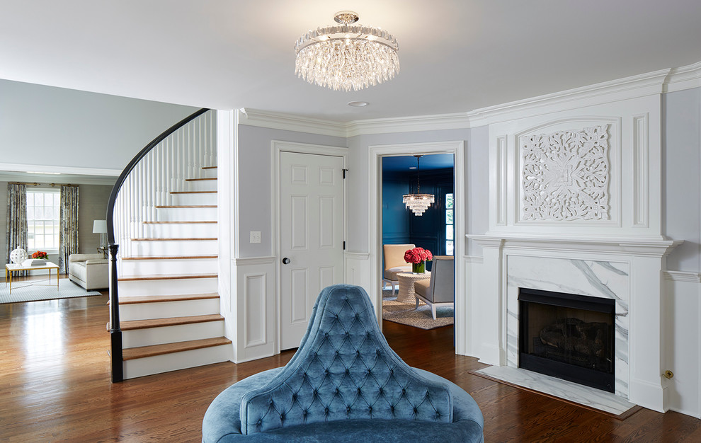 Traditional foyer in New York with brown floors, blue walls and dark hardwood flooring.