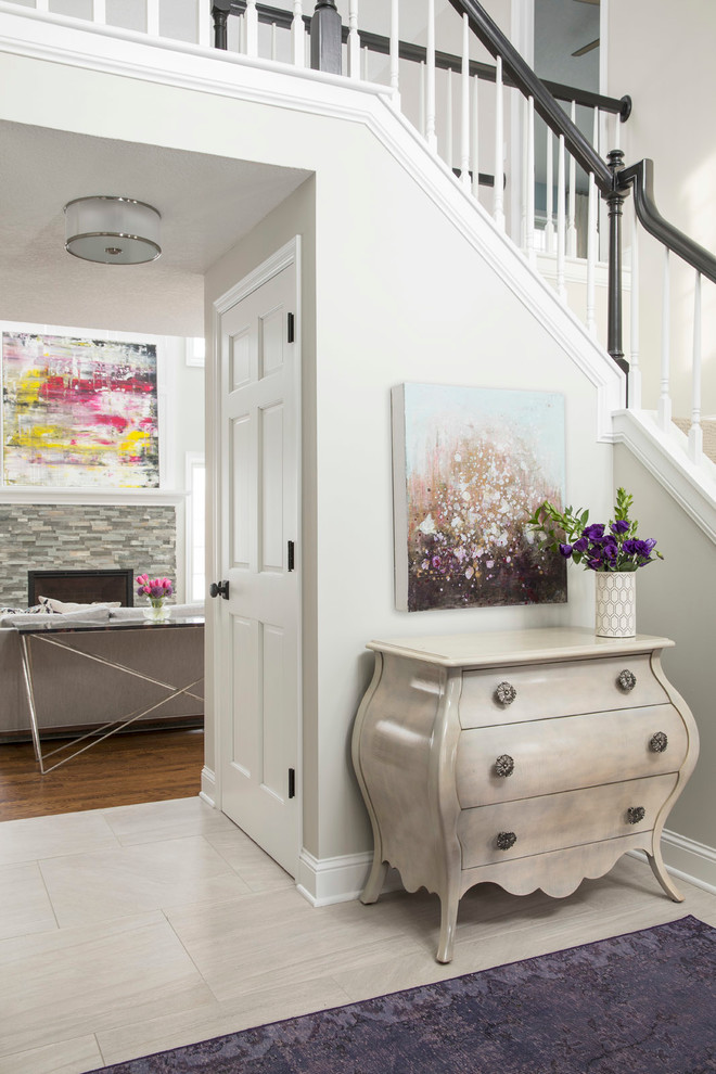 Example of a mid-sized trendy ceramic tile and beige floor entryway design in Minneapolis with beige walls and a dark wood front door