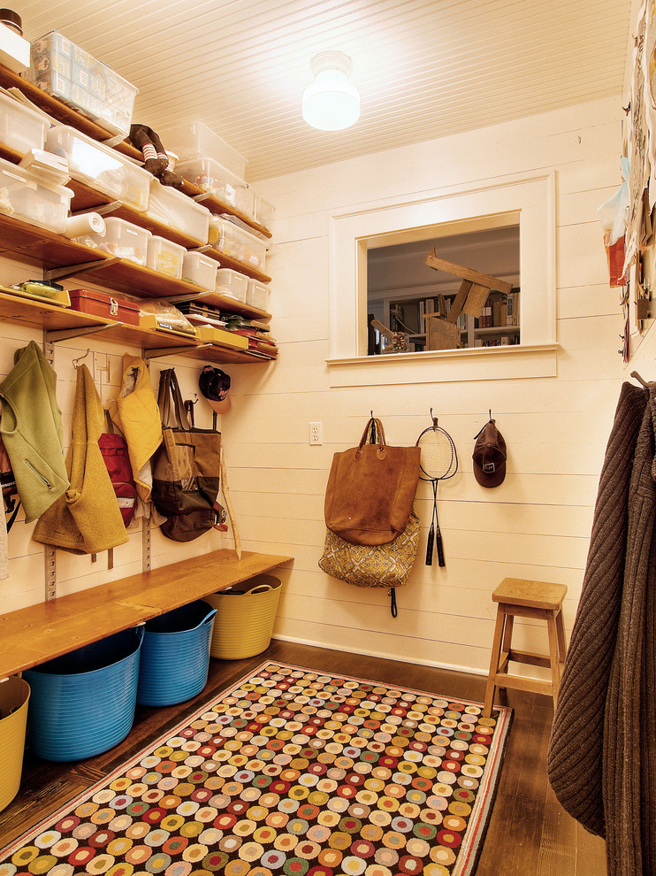 Example of a country dark wood floor mudroom design in Seattle with white walls