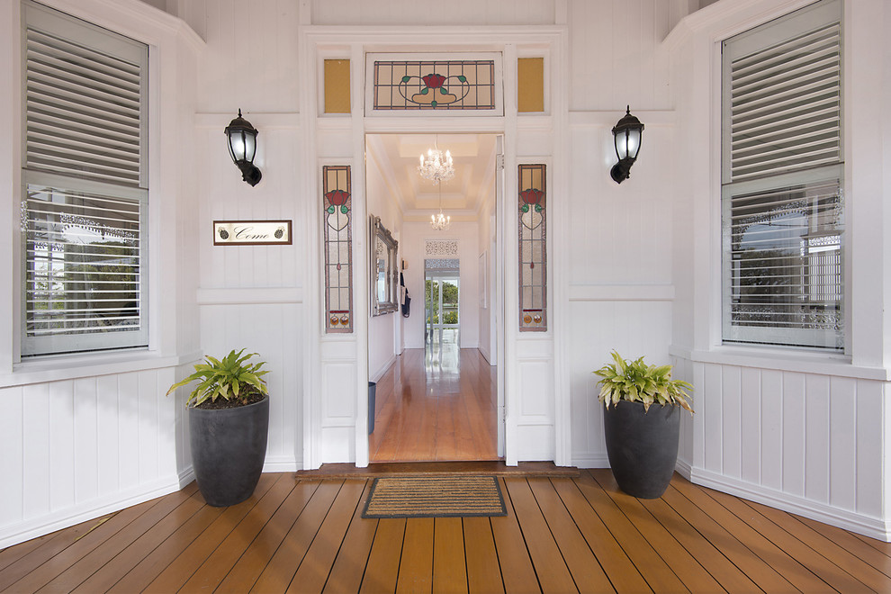 Classic entrance in Brisbane with white walls, medium hardwood flooring, a single front door and a white front door.