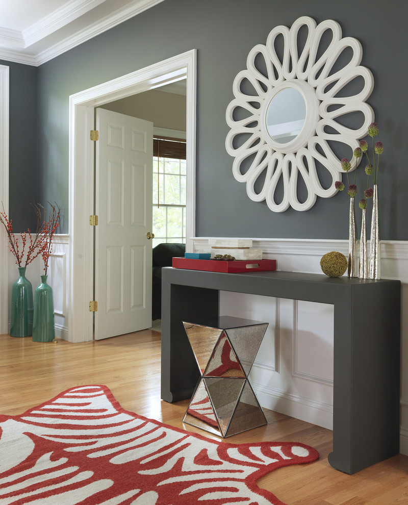 Example of a transitional light wood floor entryway design in Boston with gray walls