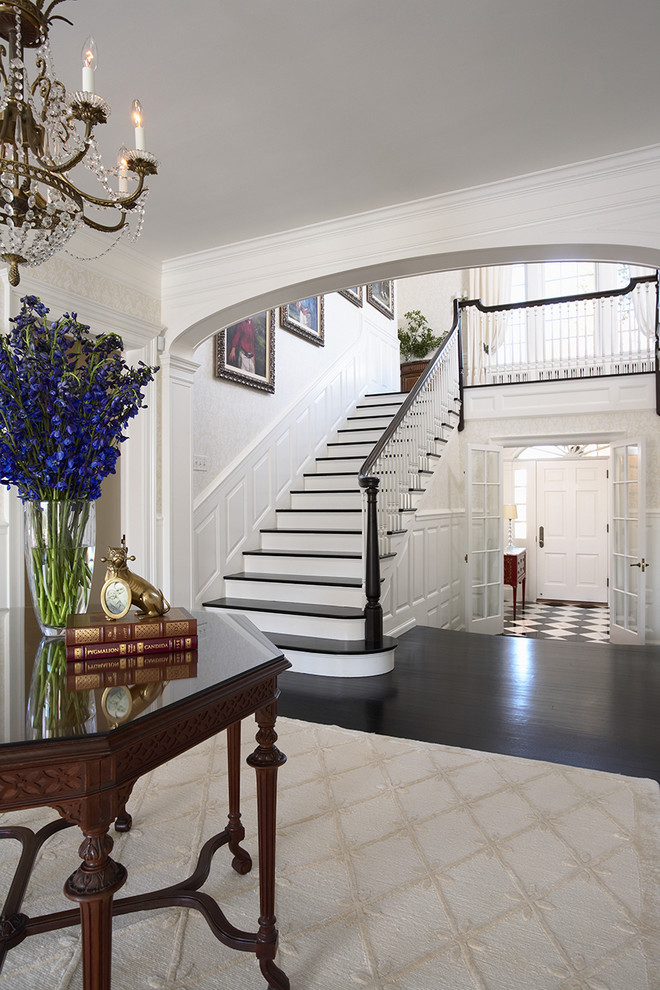 Huge elegant dark wood floor and multicolored floor entryway photo in Minneapolis with white walls and a white front door