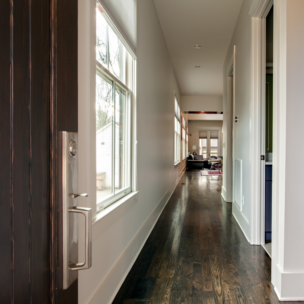 Foto de entrada clásica renovada con paredes blancas, suelo de madera oscura, puerta simple y puerta de madera oscura