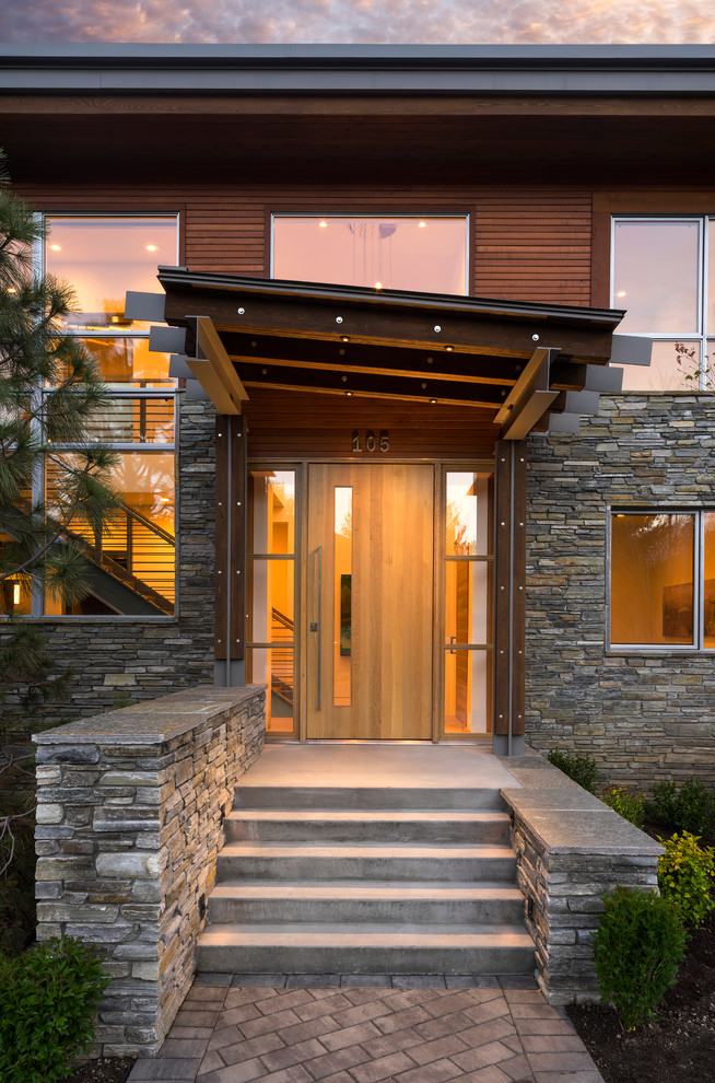 This is an example of a large rustic front door in Salt Lake City with white walls, a single front door and a light wood front door.