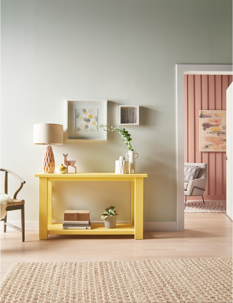 Example of a danish light wood floor and beige floor foyer design in Orange County with green walls