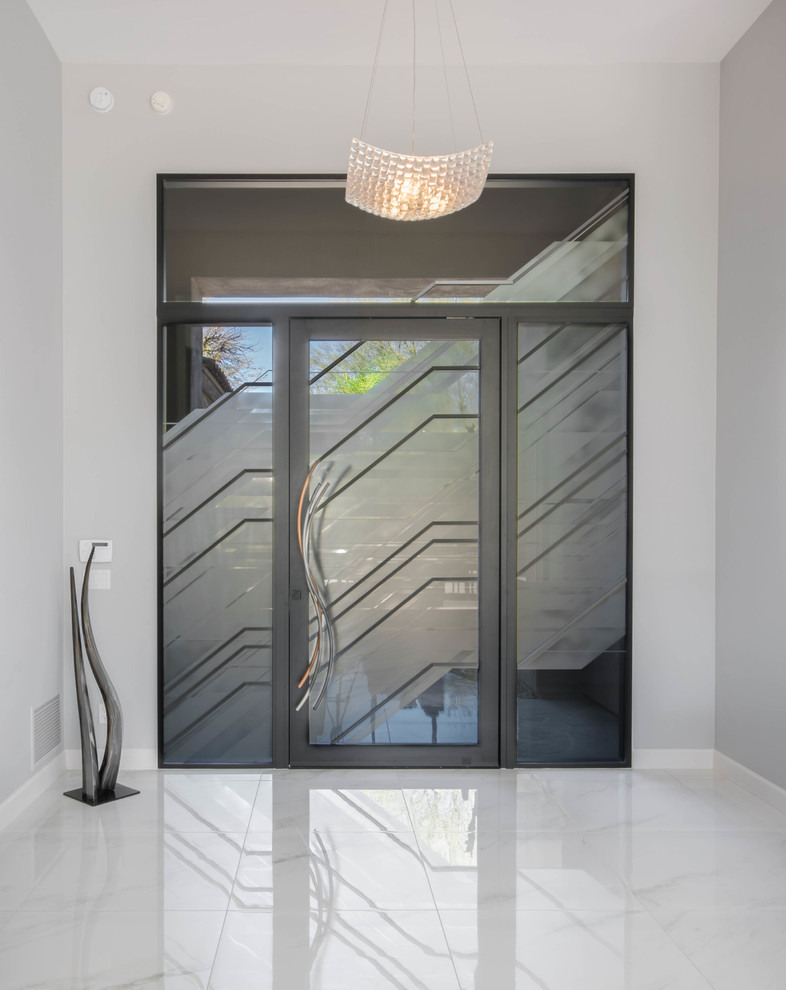 Large transitional marble floor entryway photo in Phoenix with gray walls and a glass front door