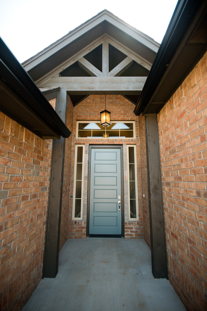Example of a mid-sized transitional concrete floor entryway design in Oklahoma City with a blue front door