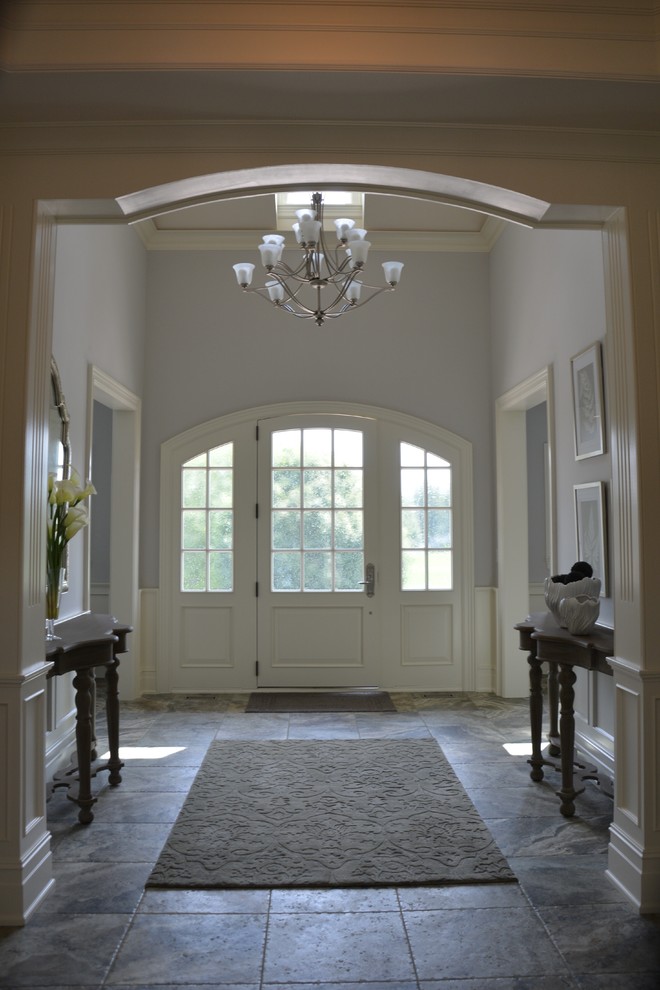 Entryway - large traditional porcelain tile entryway idea in Indianapolis with gray walls and a white front door