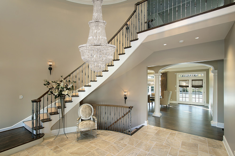 Design ideas for a large classic foyer in New York with beige walls, travertine flooring and beige floors.