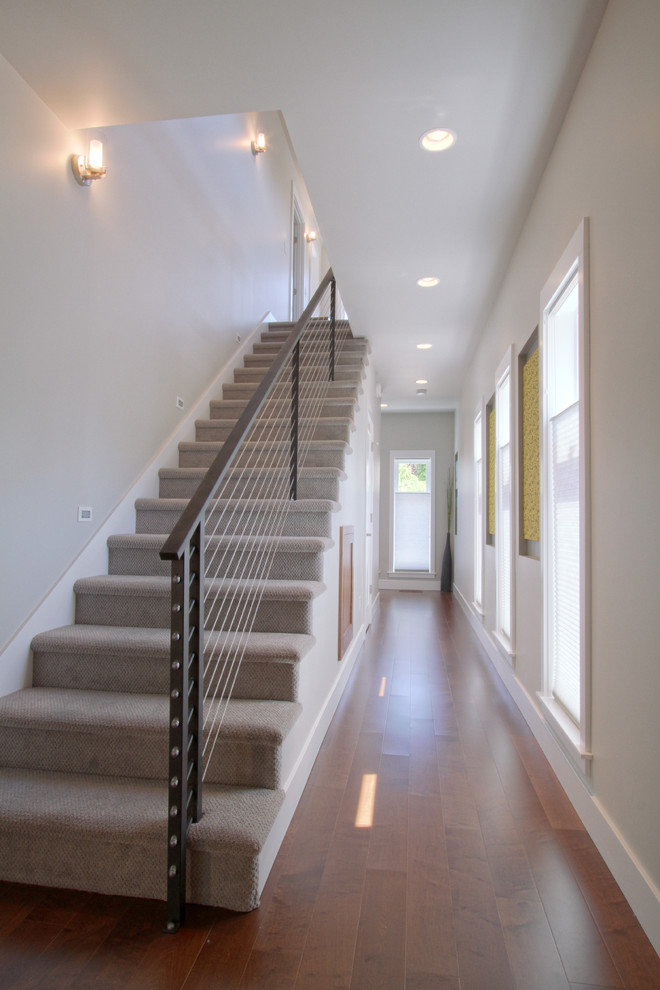 This is an example of a medium sized modern hallway in Portland with grey walls, medium hardwood flooring and a single front door.