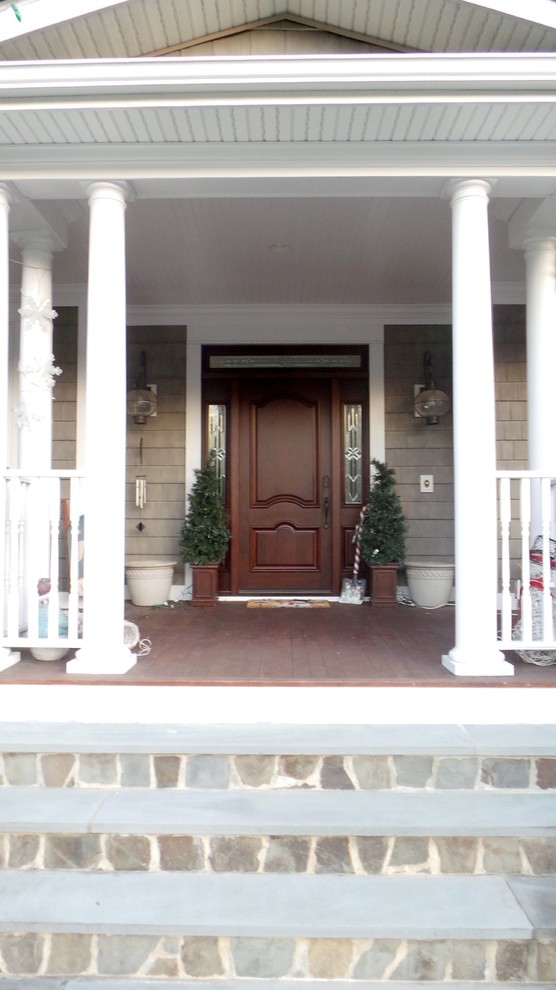 This is an example of a medium sized classic front door in New York with a single front door and a dark wood front door.