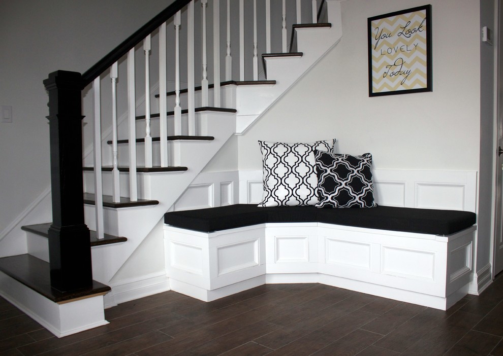 This is an example of a medium sized classic foyer in New York with grey walls and dark hardwood flooring.