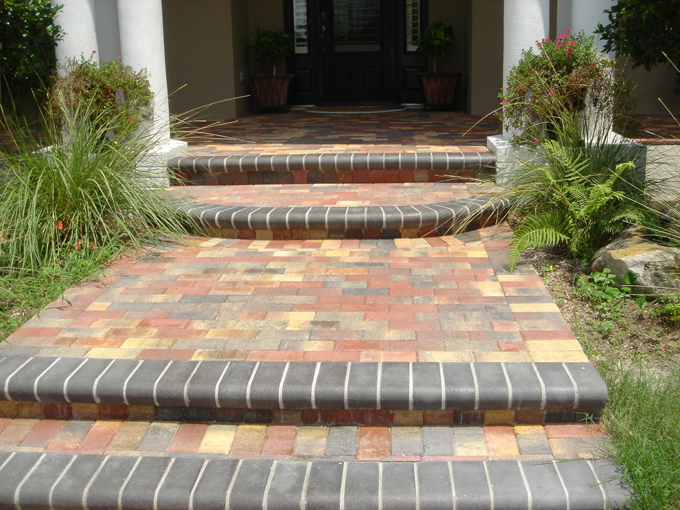 Entryway - mid-sized tropical brick floor entryway idea in Tampa with yellow walls and a medium wood front door