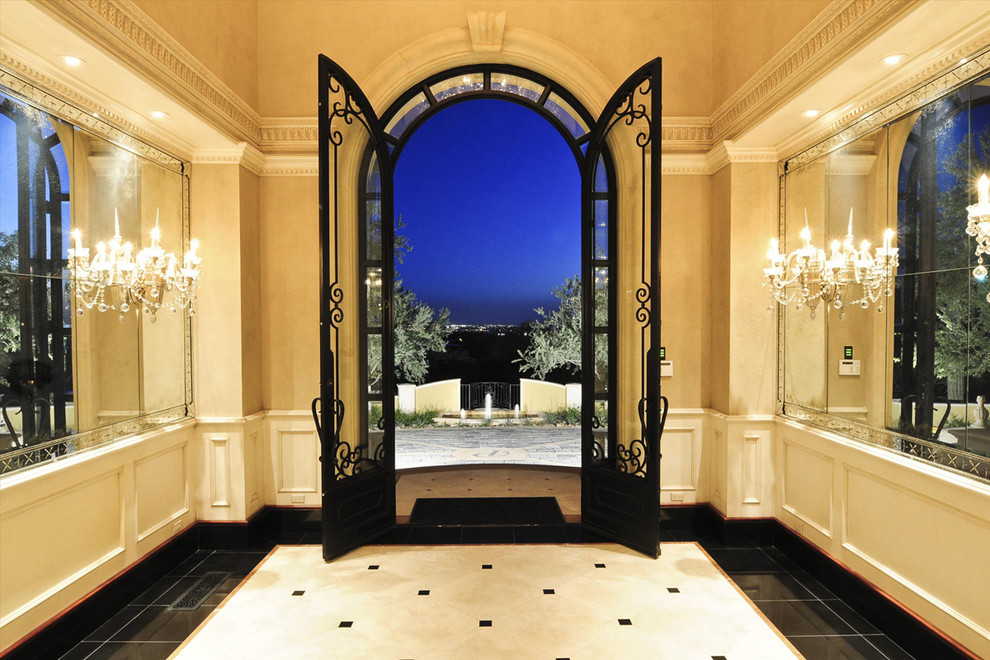 Inspiration for a large timeless marble floor entryway remodel in Phoenix with beige walls and a black front door