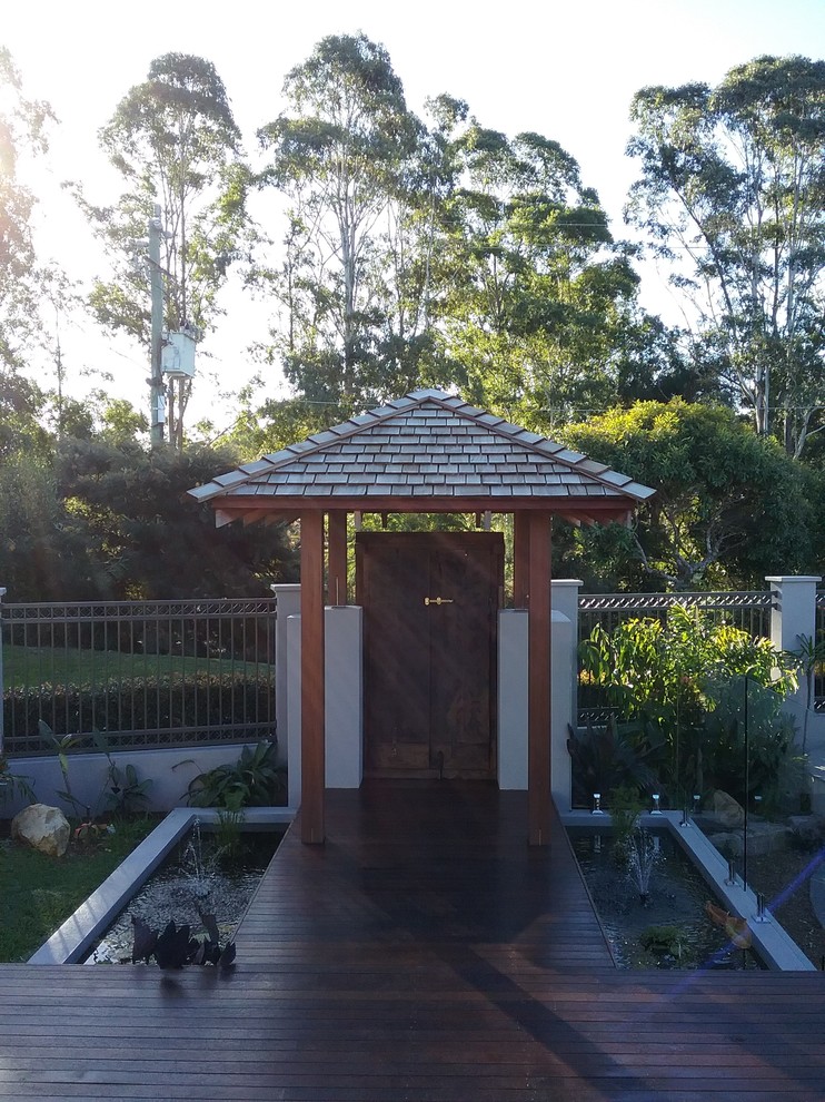 Photo of a medium sized world-inspired entrance in Sunshine Coast with grey walls, medium hardwood flooring and a medium wood front door.