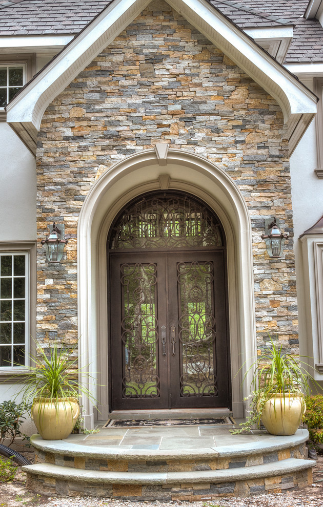 Design ideas for a large mediterranean front door in Boston with a double front door and a glass front door.