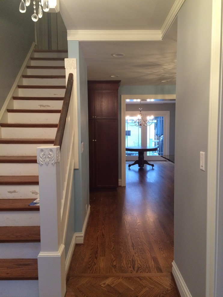 This is an example of a small traditional foyer in Chicago with blue walls and medium hardwood flooring.